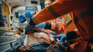 Bakersfield Pedestrian Killed in Hit-and-Run near Weedpatch Hwy, Muller Rd Female and Male EMS Paramedics Provide Medical Help to an Injured Patient on the Way to Hospital in ambulance