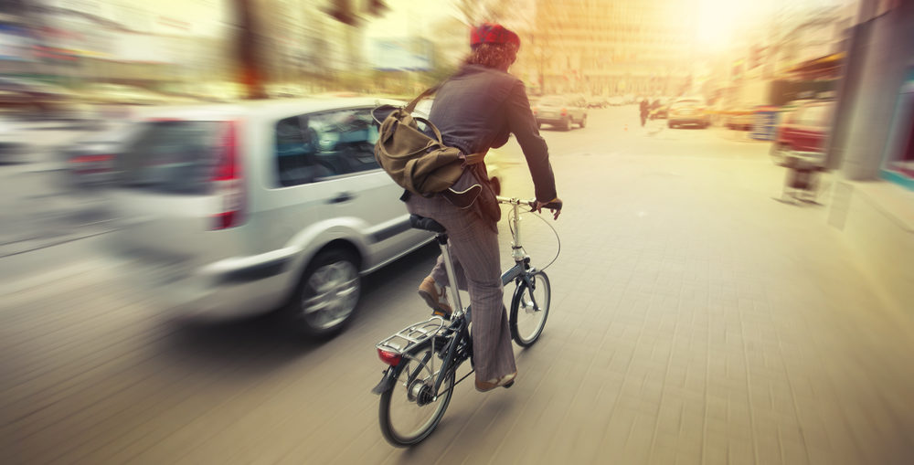 What Are The Rules Of The Road For Virginia Cyclists male cyclist in traffic on a city roadway