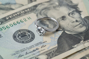 How is Alimony Awarded in Florida? diamond engagement ring on stack of us currency