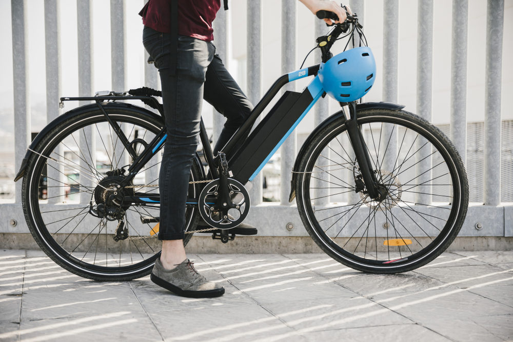E-Bike Guide: Bike Types, Laws & Dangers Urban cyclist taking a brake on e-bike
