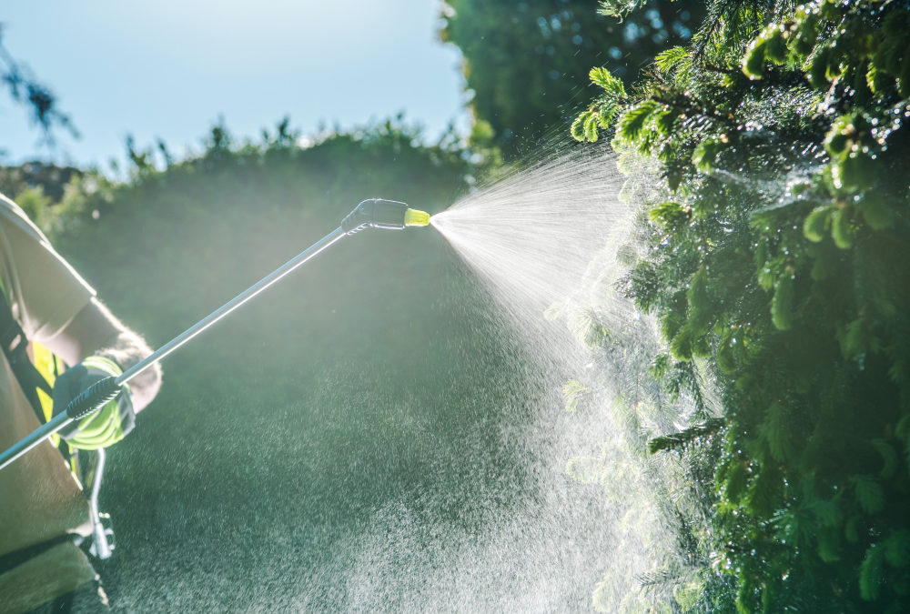 Caucasian Garden Worker with Spraying Equipment.
