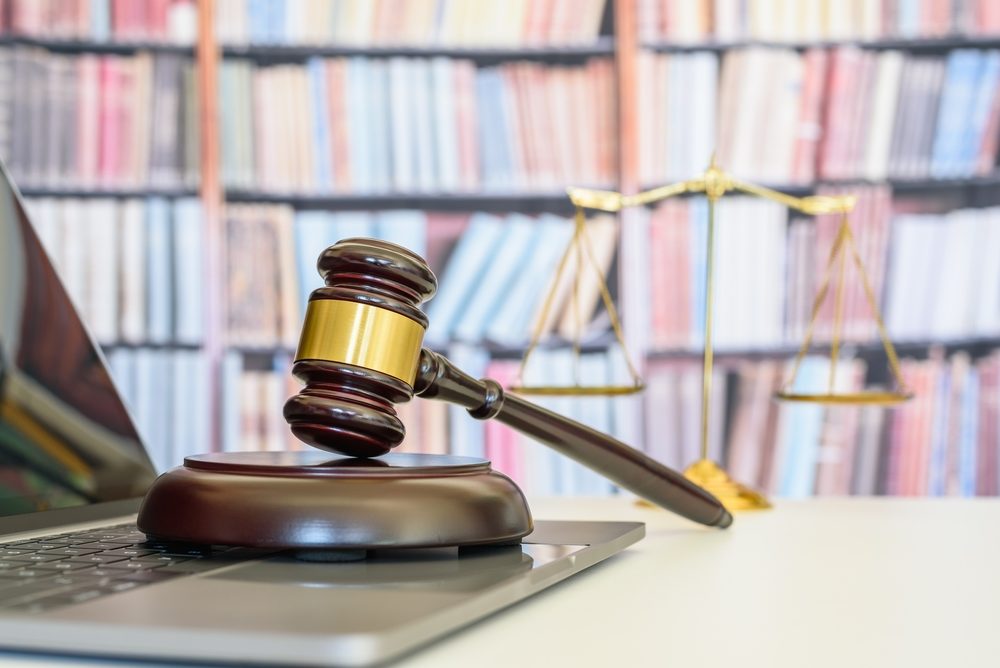 Jury Finds Former Gilman School Teacher, Christopher Bendann, Guilty of Sexual Exploitation, Child Pornography, and Cyberstalking Judge gavel or a hammer and a base used by a judge person on a desk in a courtroom with blurred weight scale of justice.
