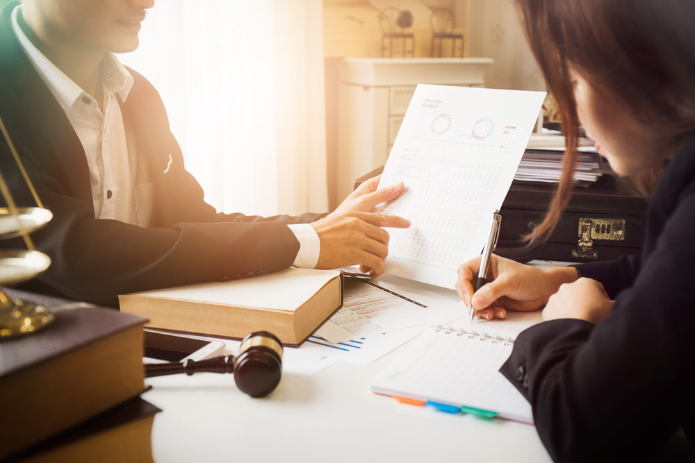 What Documents Do I Need In My Virginia Personal Injury Case? male attorney consulting a female client at desk in office.