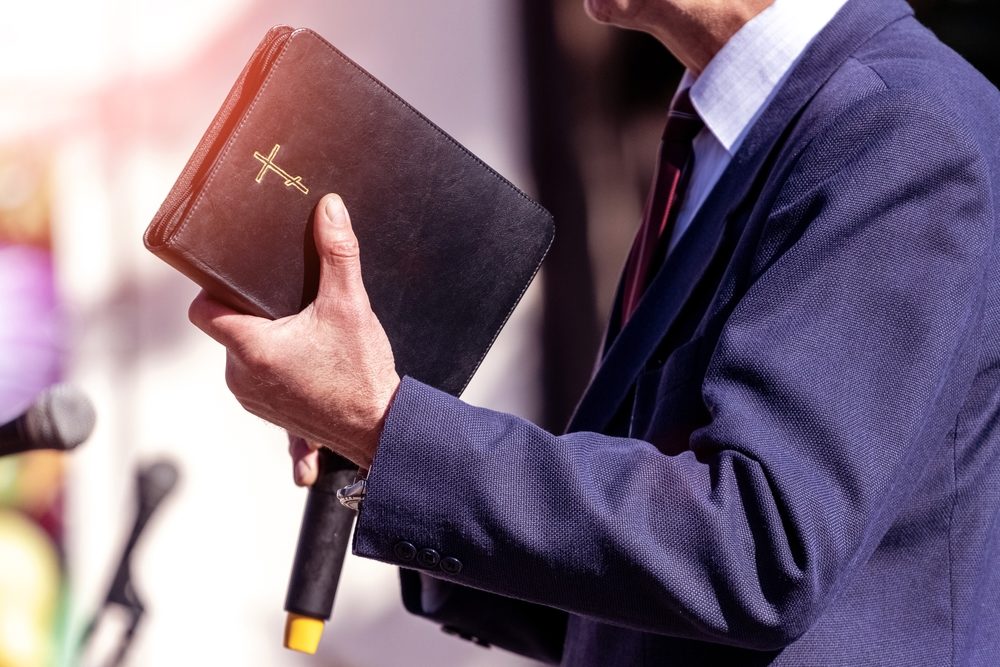 Bernard Squires Named in SBC List of Abusers Pastor with a Bible in his hand during a sermon.