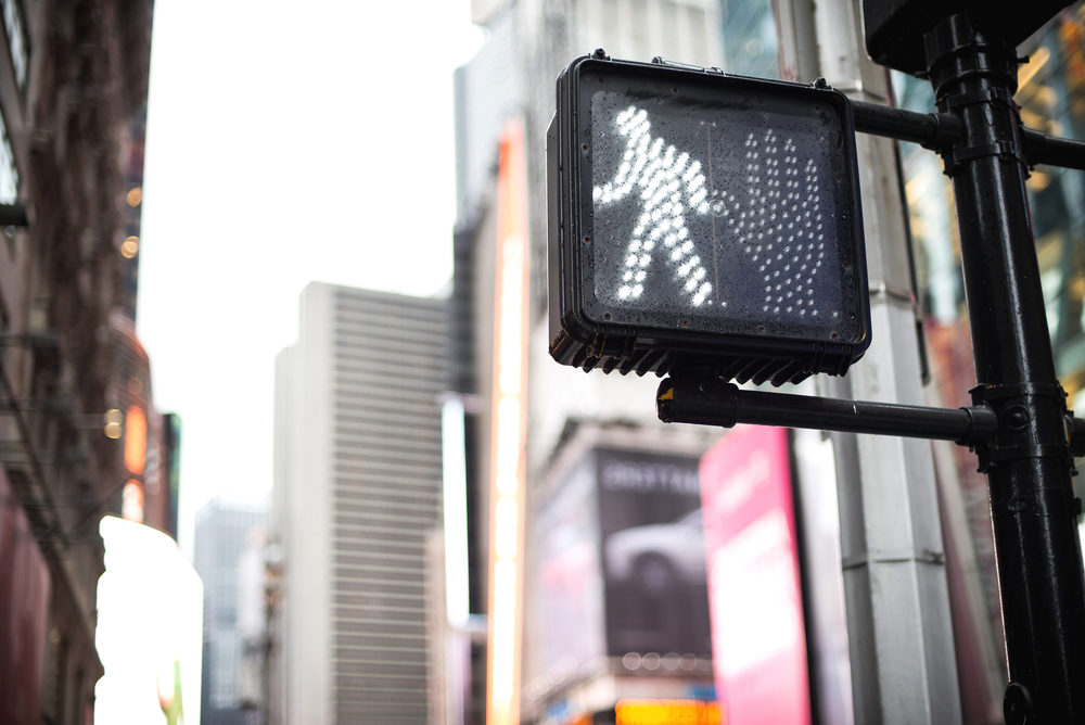 Where Do Pedestrian Accidents Occur Most Often? pedestrian crossing sign at traffic light in Manhattan