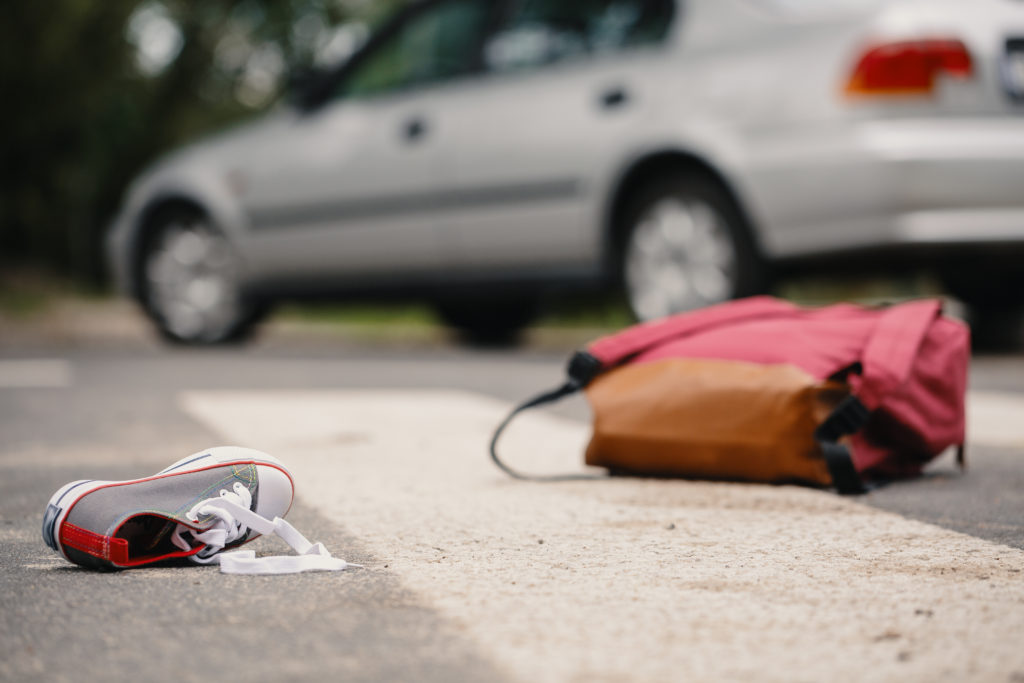 Texas Pedestrians Beware of Distracted Drivers Child's shoe and backpack after a car collision