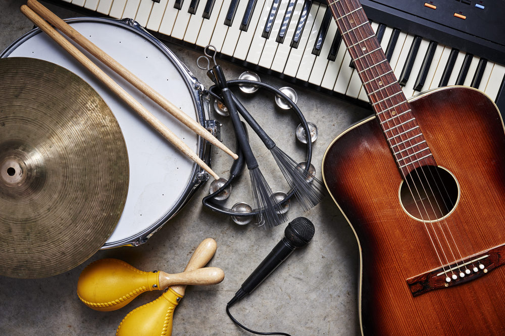 Austin ISD Band Teacher, Rodney Tyrone Childers, Accused of Paying Money to Student He Groomed and Sexually Abused Musical instruments on a concrete floor: drums, guitar, keyboard, tambourine, and maracas