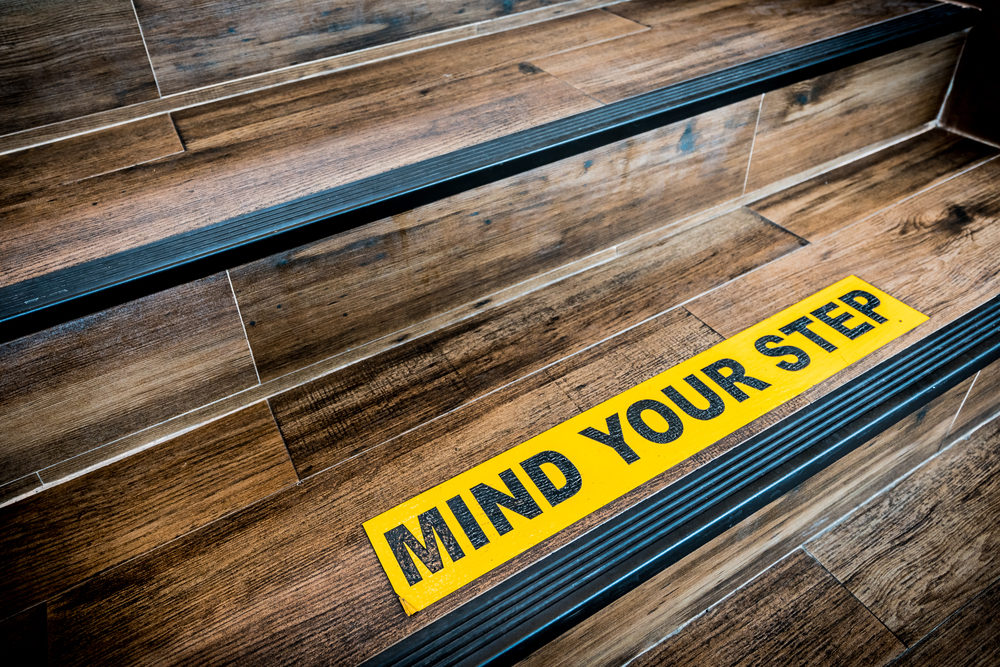 Detroit Premises Liability Slip And Fall Cases Explained Mind Your Step sign on wooden staircase