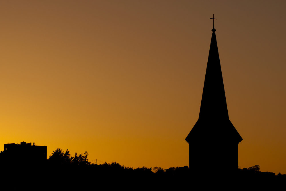 Church steeple silhouette at sunset