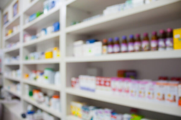 blurred pharmacy shelves with medicine stocked