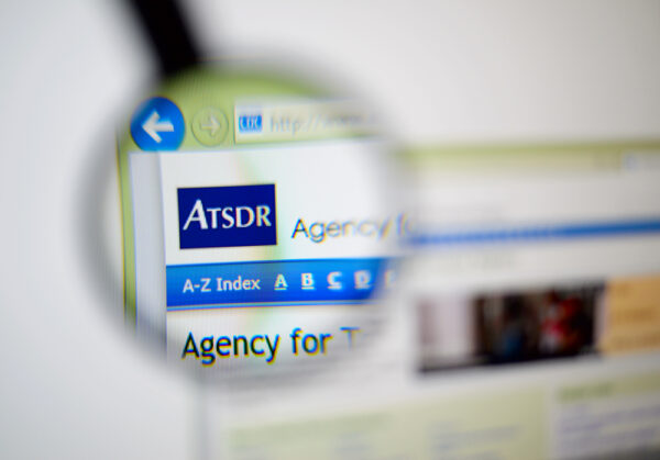 Photo of the Agency for Toxic Substances and Disease Registry (ATSDR) homepage on a monitor screen through a magnifying glass.