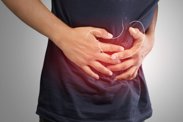 man holding his stomach with gastroparesis or stomach paralysis